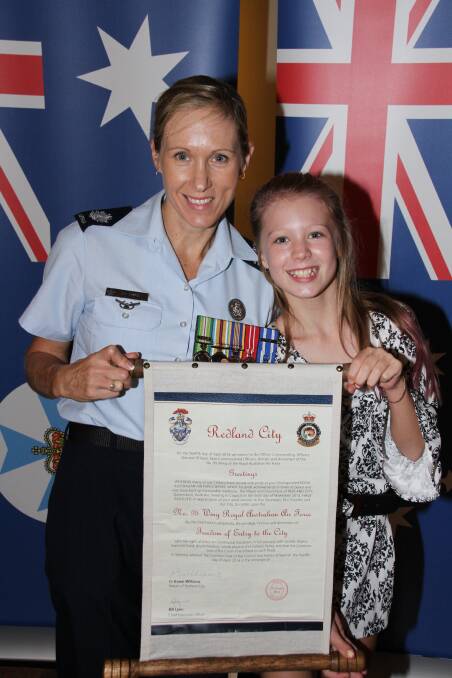 Warrant Officer Lisa Sheridan (95 Wing) with her daughter Amelia, 10, of Fernvale, with the official scroll declaring Freedom of Entry to the City of Redland.
Photo by Chris McCormack