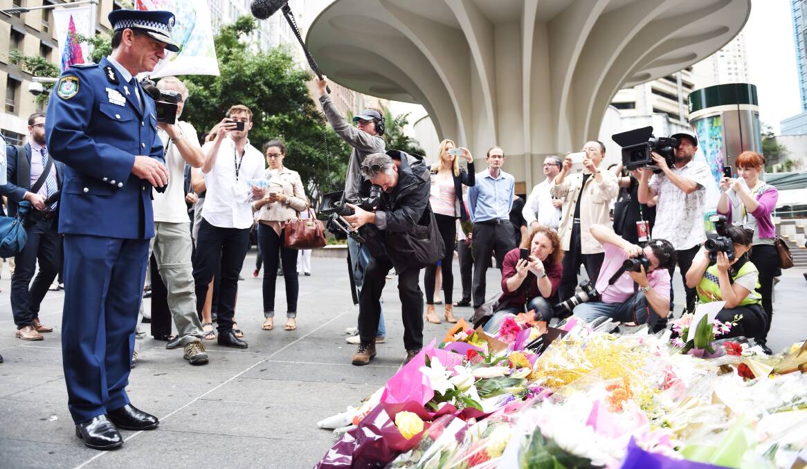 Hundreds of people have left flowers in central Sydney memory of the hostages killed in Monday's siege.