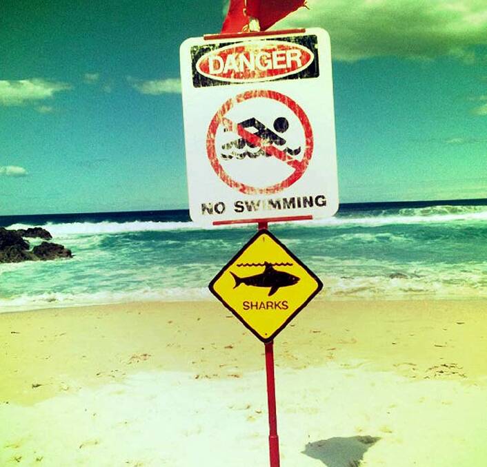 No relent from the sea either. Signs warn beachgoers to stay out of the water on North Stradbroke Island. Photo: Louise Denoon