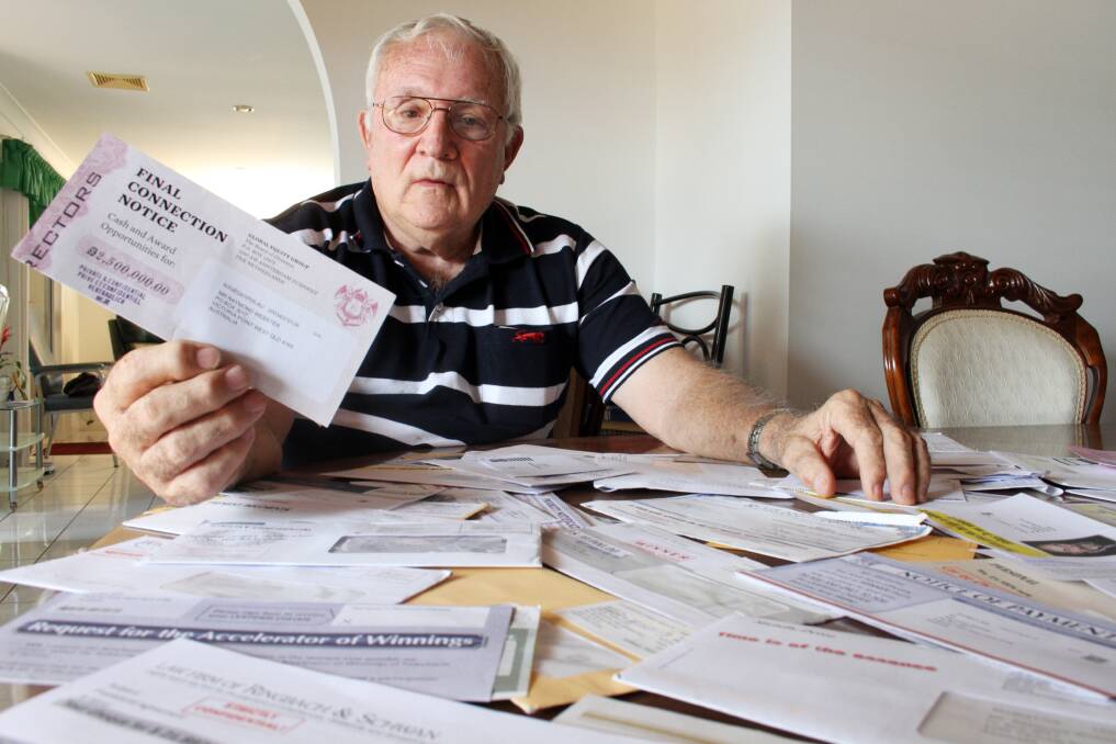 DECEMBER: Ray Webster with at least 20 scam letters demanding money for supposed lottery winnnings. Photo by Chris McCormack