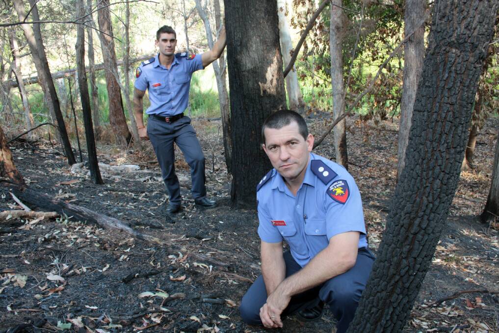 NOVEMBER: Capalaba Fire Station station officer Paul Omanski and firefighter Richard McCluskey inspect the burnt out area of bush in Capalaba. Photo by Chris McCormack