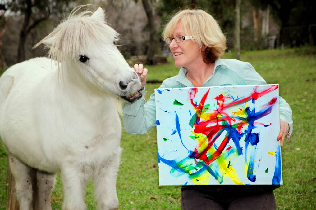 JUNE: Jill Strachan - president of the Equine Learning for Futures Inc. with 'Elf' the pony who has had a remarkable recovery after being dragged behind a car. He now paints, jumps through hoops and counts among other things. Photo by Chris McCormack