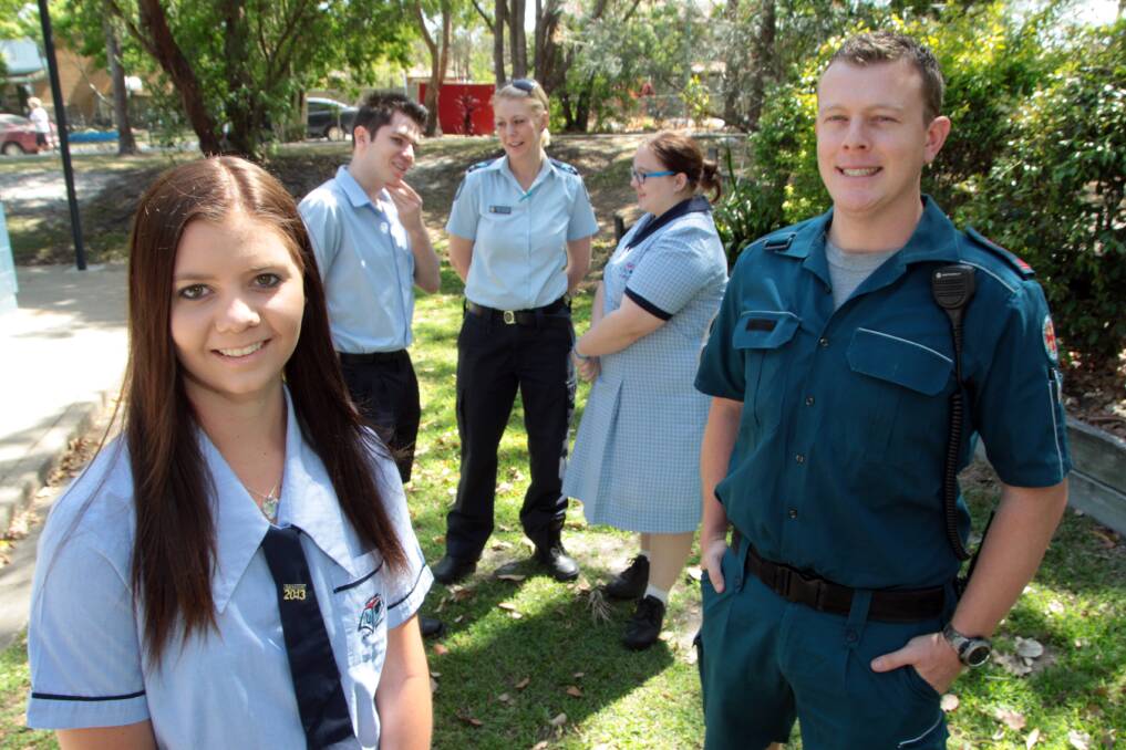 OCTOBER: Capalaba State College students from left - Samantha Green, 17, James Grice, 18 and Felicity Huet, 17 talk to senior constable Toni Orchard and Southport based QAS paramedic Mal Moss. Photo by Chris McCormack