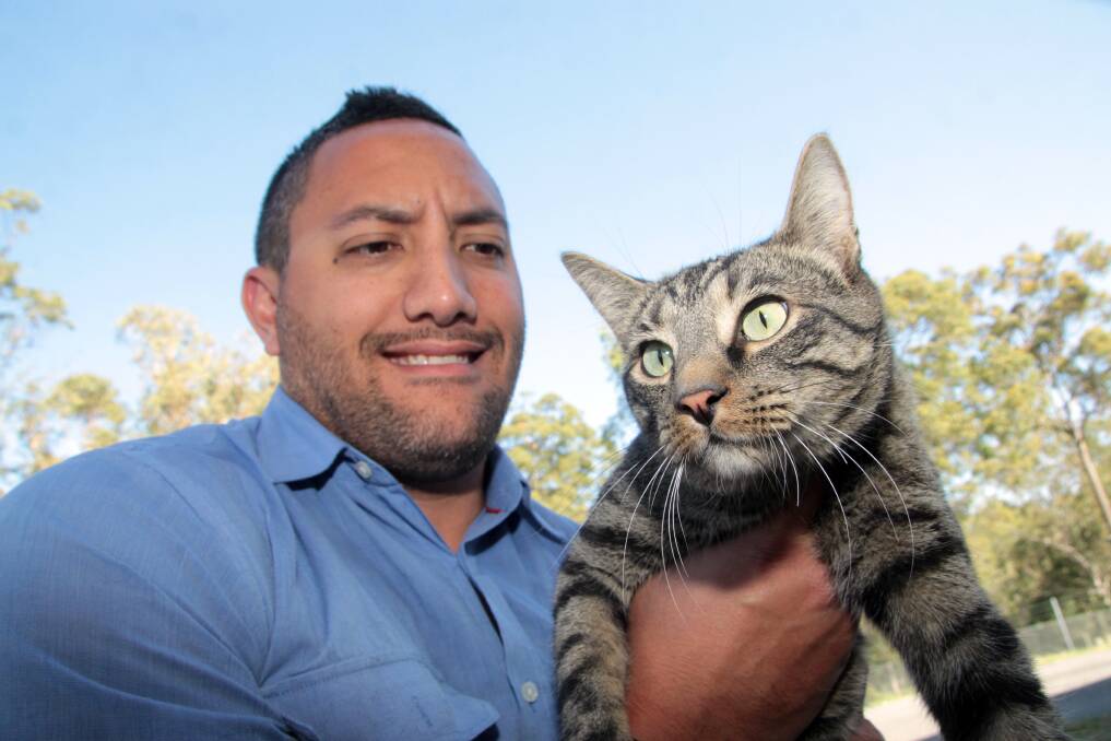OCTOBER: Redland City Council animal management officer Matt Tongiatama with one of the cats at the shelter. Photo by Chris McCormack