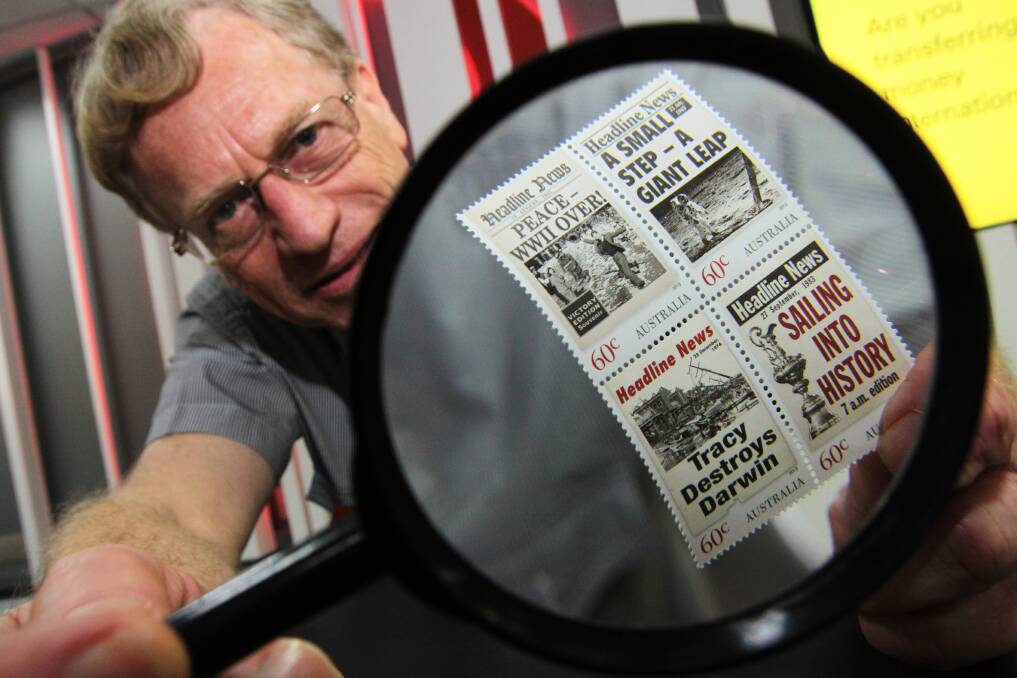 JULY: Australia Post Cleveland postal services officer Vern Williams inspects the new stamps. Photo by Chris McCormack