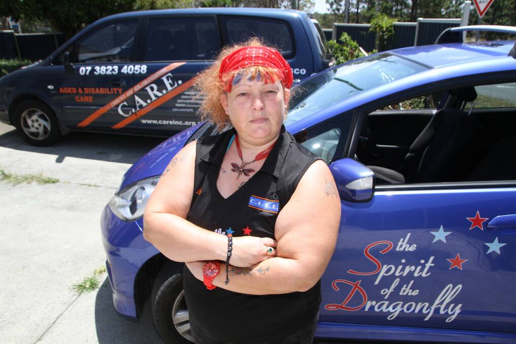 NOVEMBER: Lisa-Jane Luck with the two CARE vehicles that were broken into in Capalaba. Photo by Chris McCormack