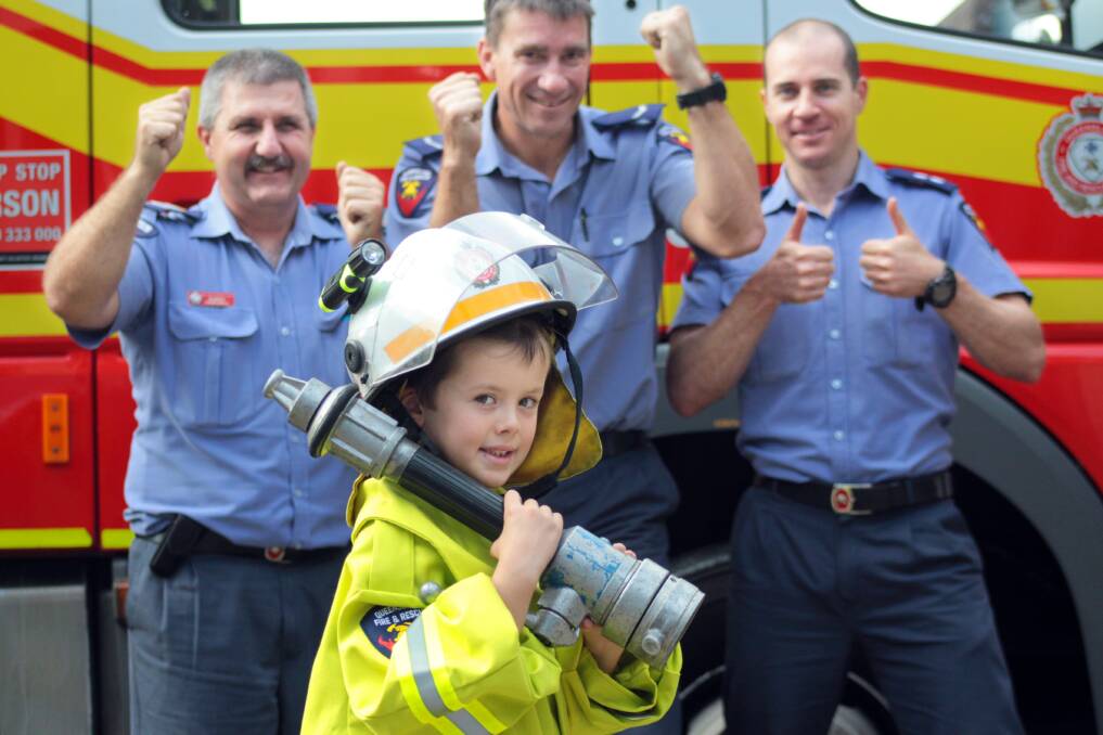 JULY: Six year old firefighting hero Hayden Crossley with Cleveland fire station crew Robert Hawxwell, Scott Dinsdale and Kirby Ogborne. Photo by Chris McCormack