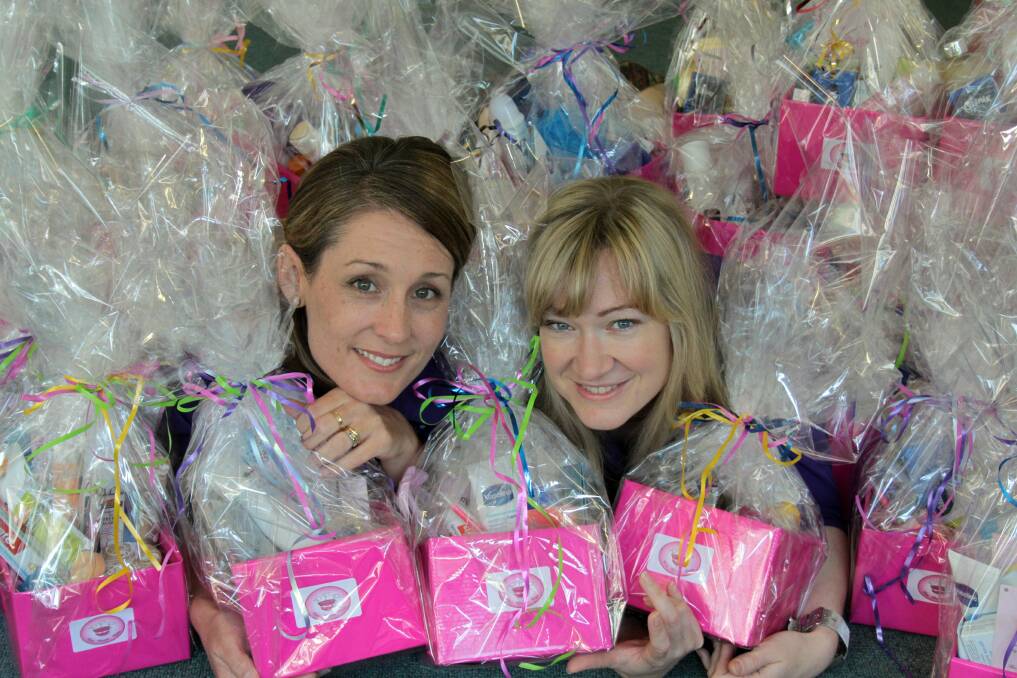 SEPTEMBER: Pink Pamper Pack co-ordinator  Deb Kolomeitz and volunteer co-ordinator for the Redland Centre for Women Amy Crouch with some of the Pink Pamper Packs. Photo by Chris McCormack