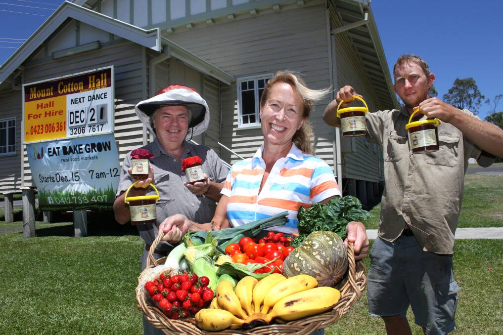 DECEMBER: Gearing up for the Eat, Bake, Grow markets at Mt. Cotton Hall is beekeeper Paul Sattler of Mt. Cotton Apiaries, markets organiser Anne Francis and organic farmer Ashley Palmer with some of the produce on offer. Photo by Chris McCormack
