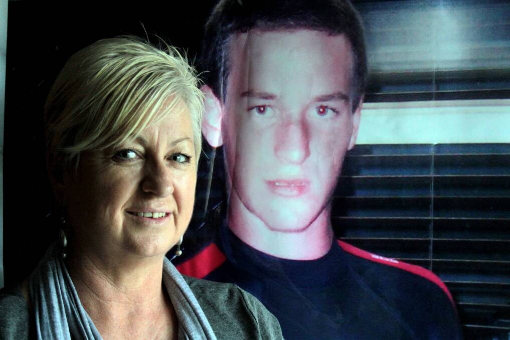 JULY: Cheryl Cuell with a photo of her son Taylor who committed suicide in 2009. Photo by Chris McCormack