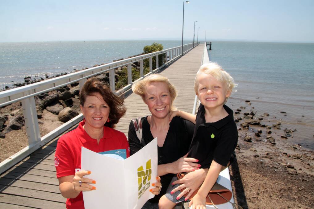 OCTOBER: Brisbane Greeter Christine Mirls of Ormiston explains some of the Moreton Bay attractions to Tara and Evan Williams of Wellington Point at the Wellington Point jetty. Photo by Chris McCormack