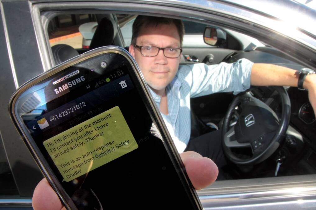 JUNE: Mark Jones with the smartphone application that sends an automated voice and text response to the caller when driving . Photo by Chris McCormack