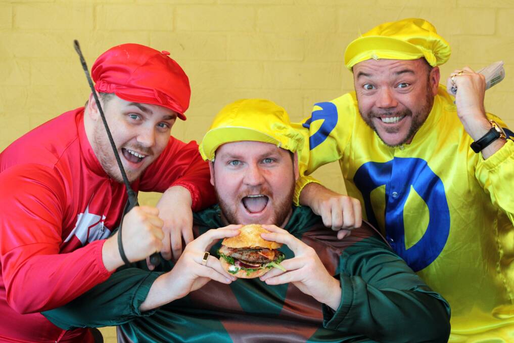 NOVEMBER: Director Dan Randall from Wellington Point, floor manager Richard  and co-host Jesse McDonald from Cleveland get in the spirit of Melbourne Cup day with a World's Hottest Burger. Photo by Chris McCormack