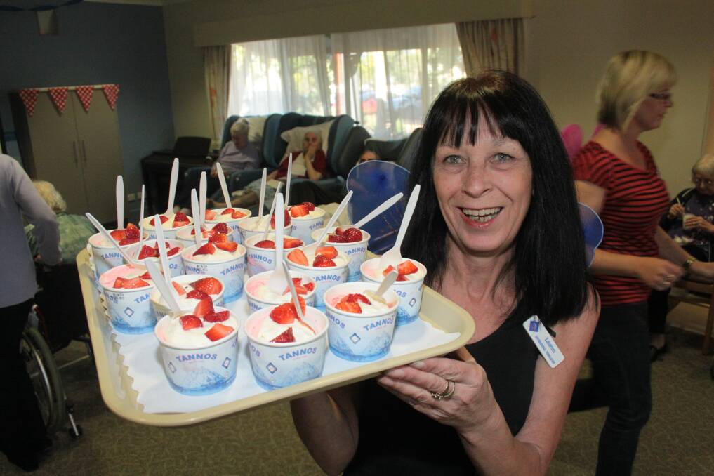 AUGUST: Moreton Shores Residential Care diversional therapist Lauren Murphy hands out the strawberry sundaes . Photo by Chris McCormack