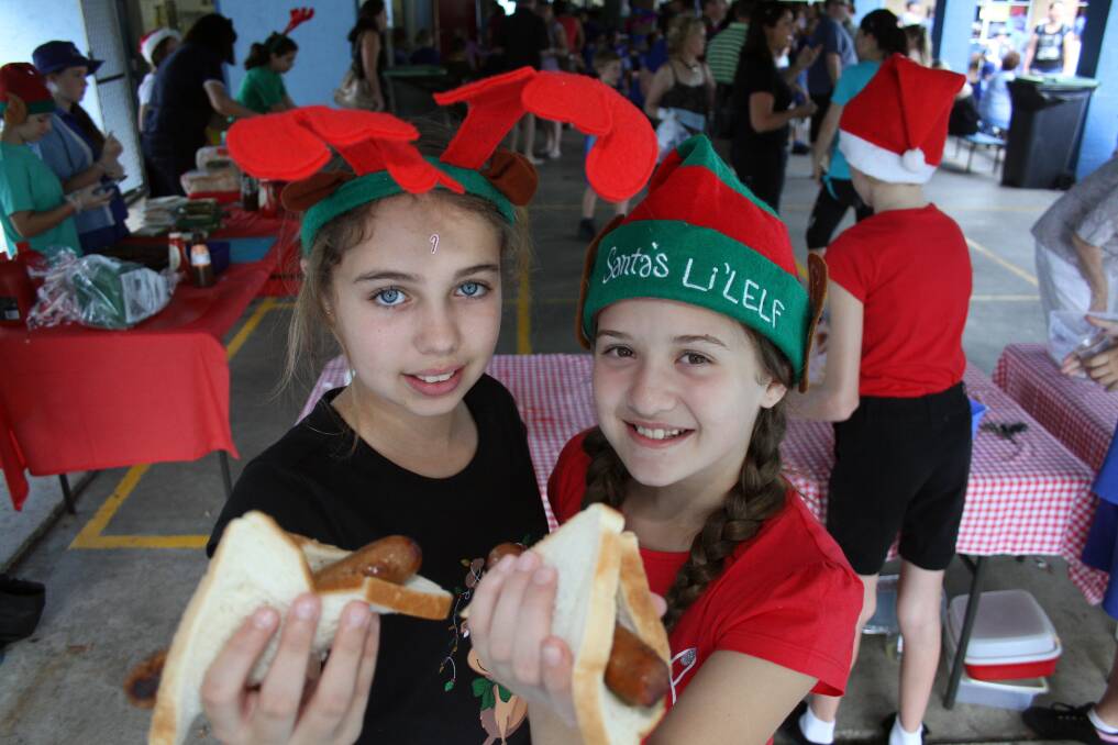 NOVEMBER: St Lukes primary school  Capalaba grade 7 students Georgina Morris and Ivana Mudnic with the sausages at the Big Brekkie. Photo by Chris McCormack