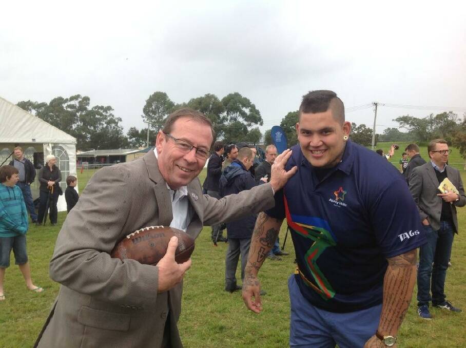 Redlands MP Peter Dowling takes on gridiron rookie Jesse Williams, who returned to Redlands this morning to help the state launch the second stage of a funding initiative. PHOTO: Peter Dowling
