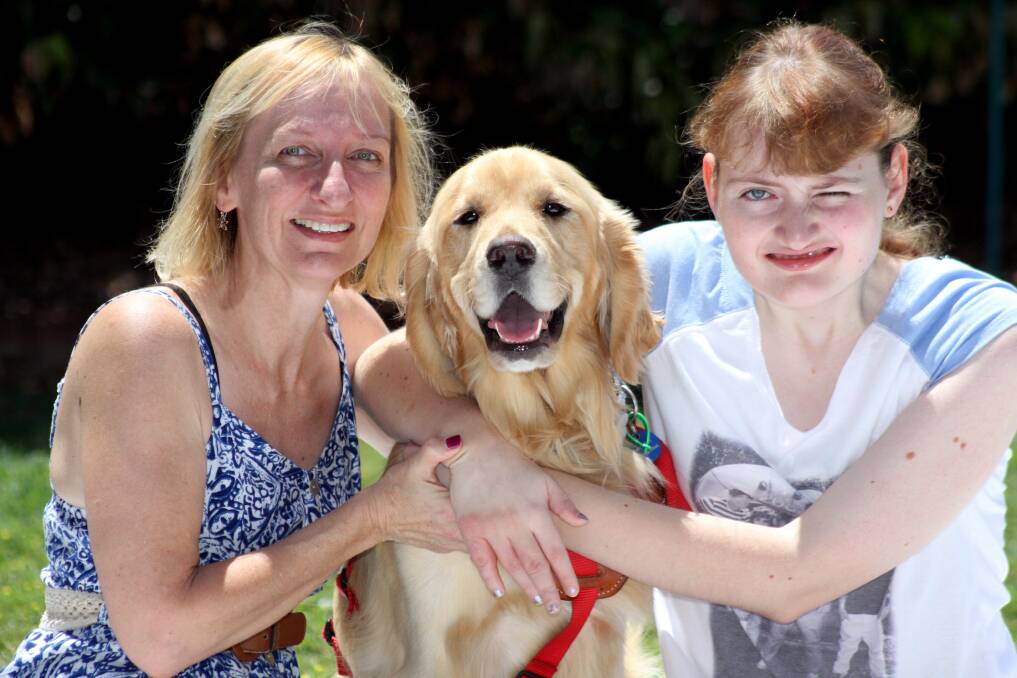 NOVEMBER: Kate and mum Heather Jennings with 'Koopa' a   seizure response/mobility assistance dog. Photo by Chris McCormack