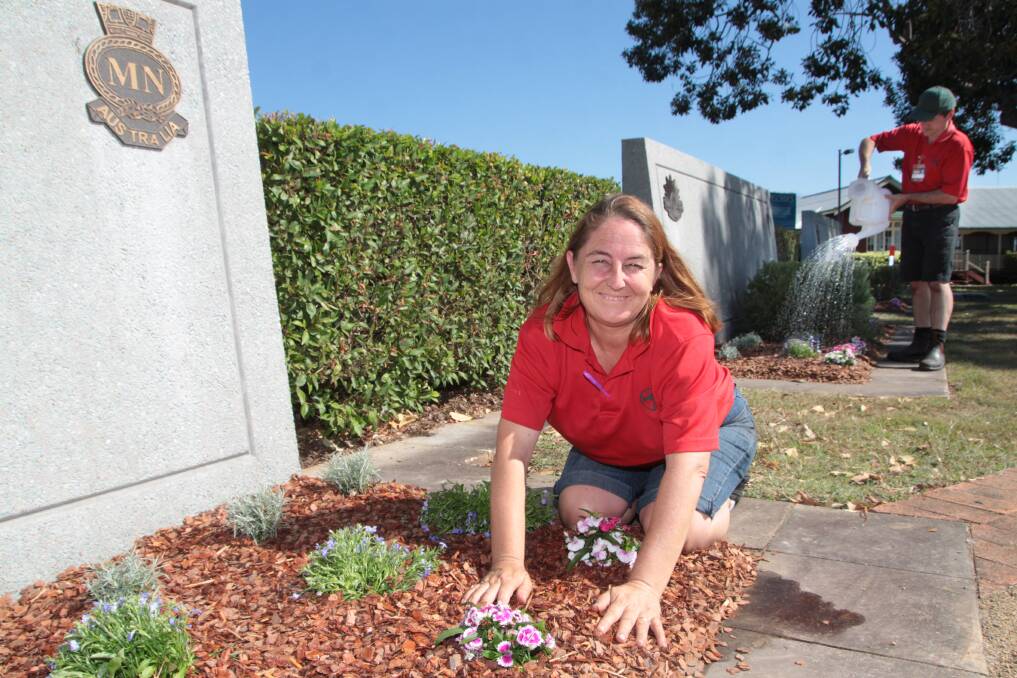 OCTOBER: Bunnings Warehouse Capalaba activities organiser Sharon Neale and complex manager James Randerson plant the new memorial garden at the Cleveland cenotaph. Photo by Chris McCormack