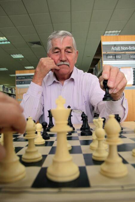JUNE: Beginners Chess tutor at Cleveland library Don Mohr, 77 of Thorneside makes a move. Photo by Chris McCormack