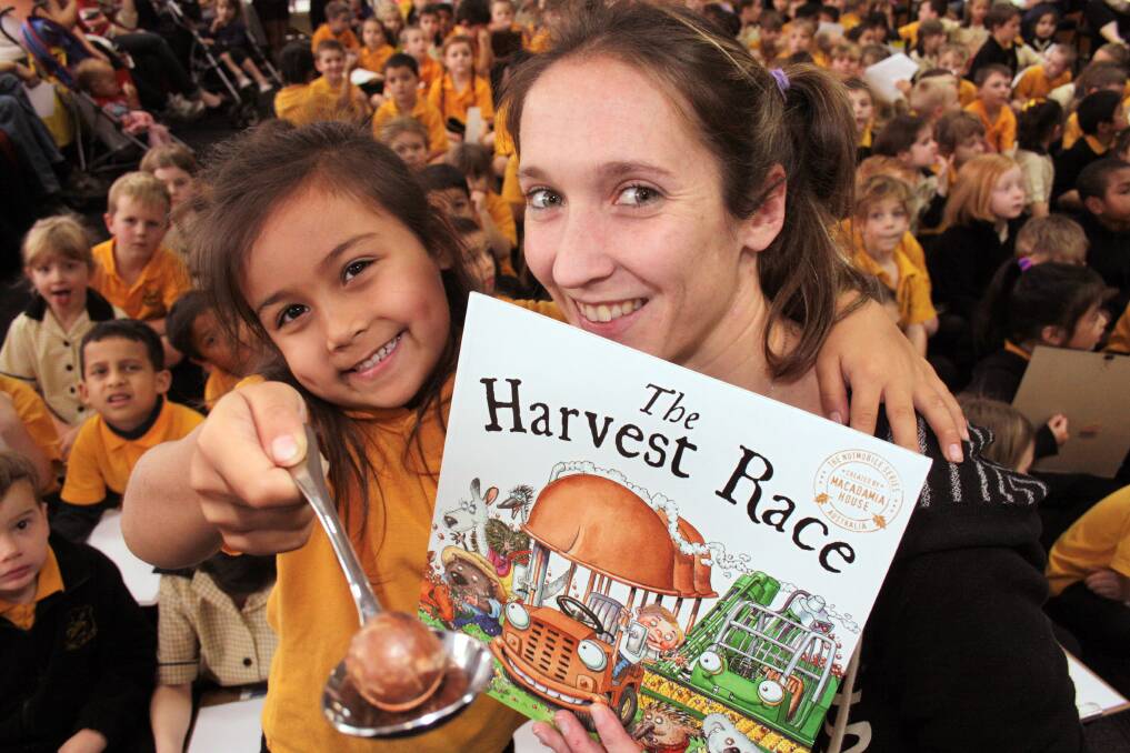 JULY: The Harvest Race author Em Horsfield with Cleveland State School year 1 student Azailea Jurd at the launch of the new childrens book. Photo by Chris McCormack