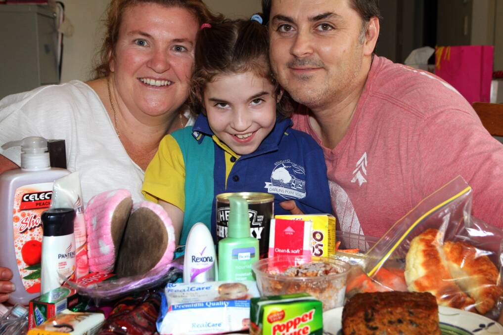 NOVEMBER: Jodie, Bella, 10 and Jason Derriman of Capalaba are putting together hampers and cooking meals for parents staying with kids at several Brisbane hospitals. Photo by Chris McCormack
