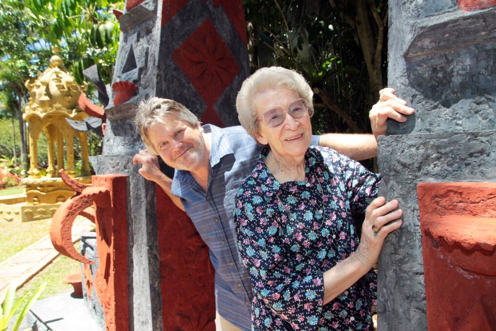 OCTOBER: Dallas Kampe has opened his Tropical garden in Mt. Cotton to pensioners and the disabled for tours. Mavis McCall of Alexandra Hills enjoys the new Balinese gate addition to the garden.  Photo by Chris McCormack
