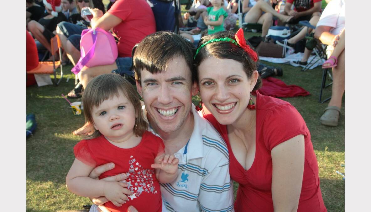 Charlotte 16 months, with  Scott and Fiona Mitchell of Wellington Point.enjoying the Christmas by Starlight concert at Norm Price Park, Cleveland Showgrounds.