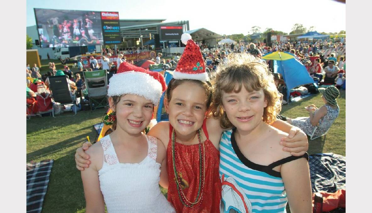 Tianna Spiteri, 9 of Wellington Point, Laura Jackson, 9 of Ormiston and Chelsea James, 9 of Cleveland enjoying the Christmas by Starlight concert at Norm Price Park, Cleveland Showgrounds.