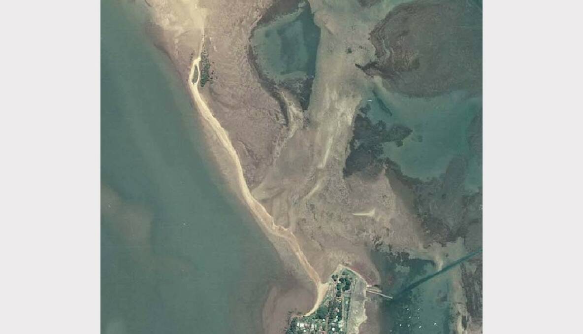 Taken in 1978, this aerial view of King Island, top left-hand side of the photo, shows less vegetation and land mass on the western side of the island compared with photos talken in 1958.