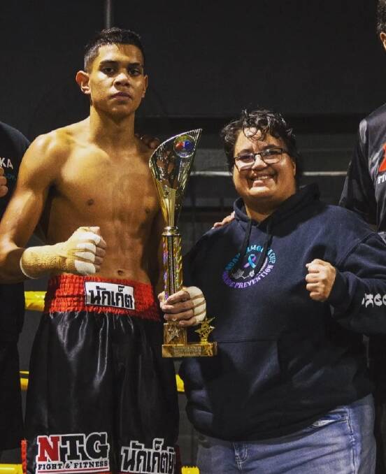 WINNER TAKES ALL: Young boxer Izaac takes a championship with the support of Sandy Heilig and the Supajai Gym.