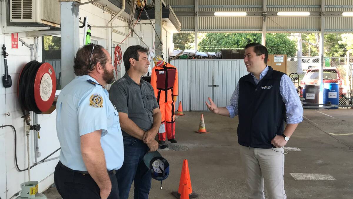 LNP MPs Mark Robinson (state) and Henry Pike (federal) speak with a Volunteer Marine Rescue member. Picture supplied.