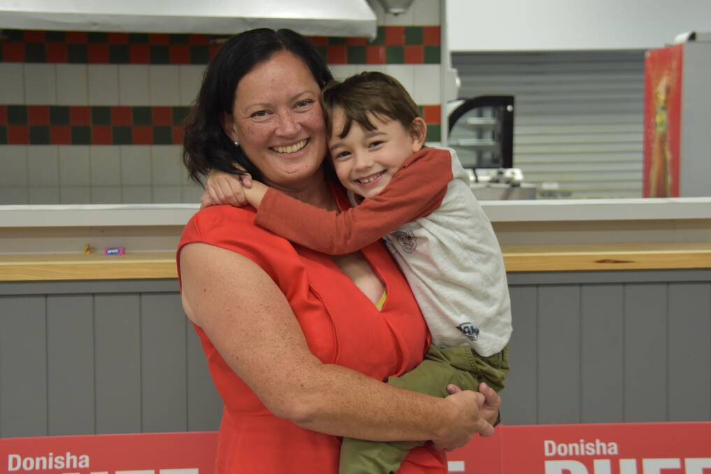 PROMISES: Labor Bowman Candidate Donisha Duff with son Alistair as votes were being counted on Saturday Night. Picture: Emily Lowe.