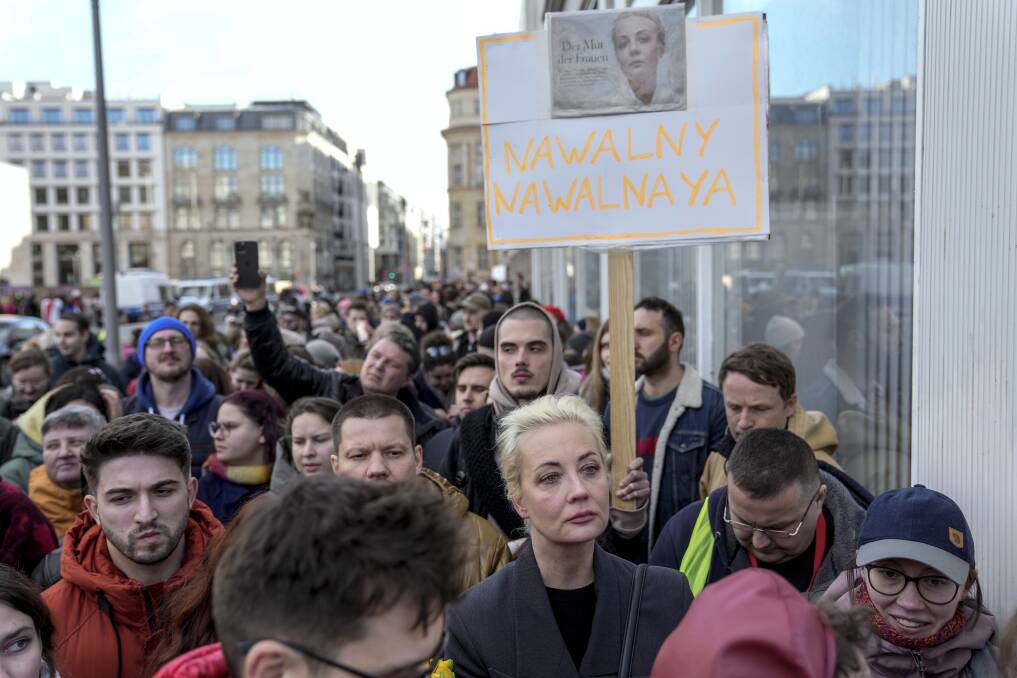 Yulia Navalnaya, center right, widow of Alexey Navalny, stands in a queue with other voters at a polling station near the Russian embassy in Berlin, after noon local time, on Sunday, March 17, 2024. (AP Photo/Ebrahim Noroozi)