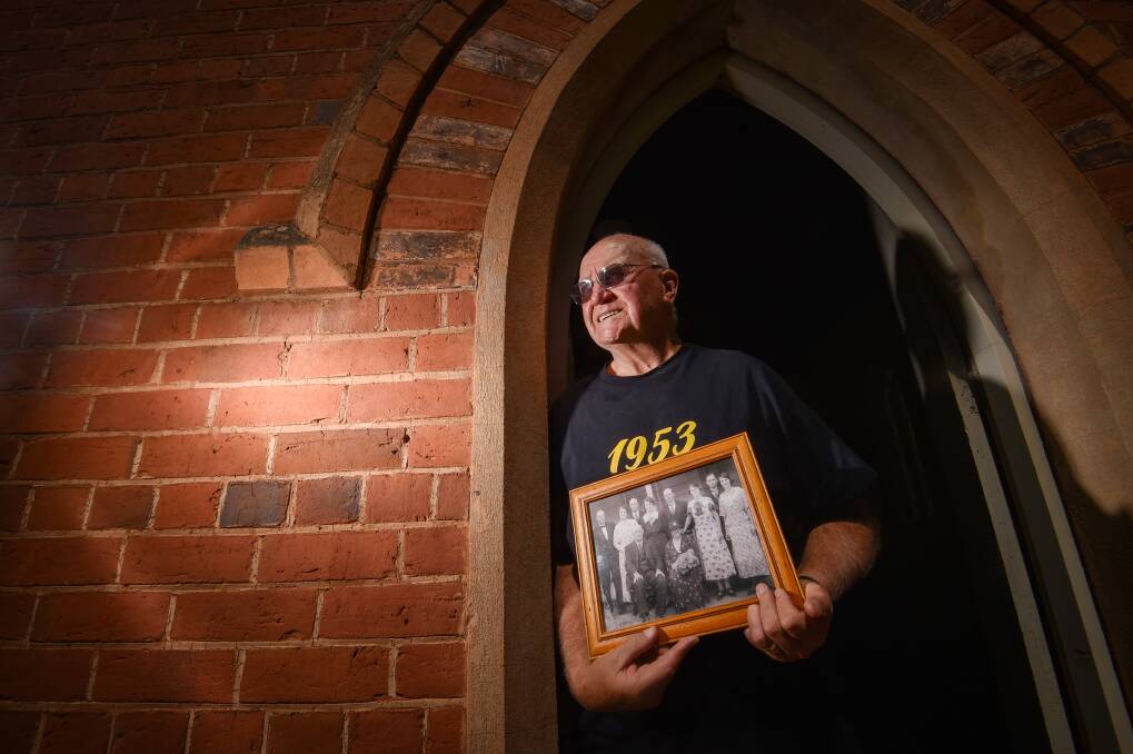 Norm Roberts holds a photos of his family who lived "an hour by horse" from the reserve. Picture by Darren Howe