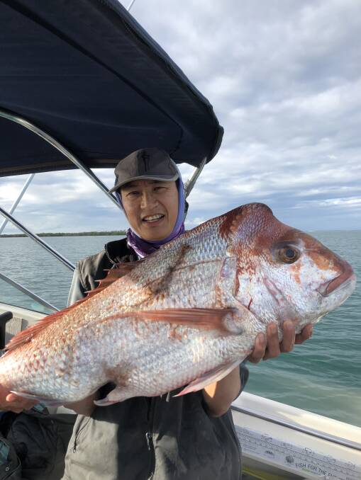 Arthur Woo proudly displays an 88-centimetre snapper caught east of Cape Moreton.