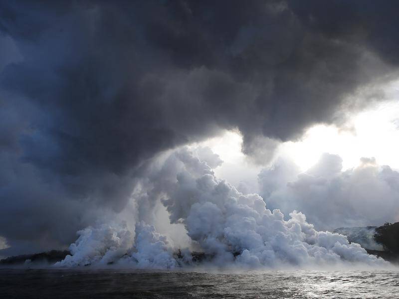 Lava from a Hawaiian volcano has pierced the roof of a tourist boat, injuring 23 people.