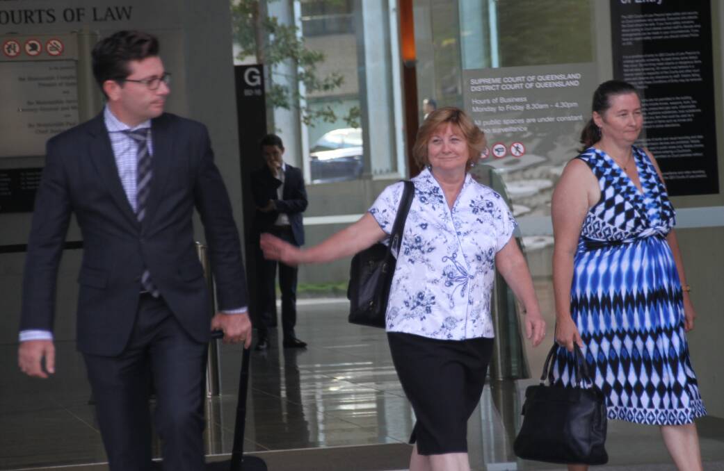 Defence lawyer Michael Gatenby with Steven Fennell's wife, Helen, far right, leaving court. Photo: Judith Kerr