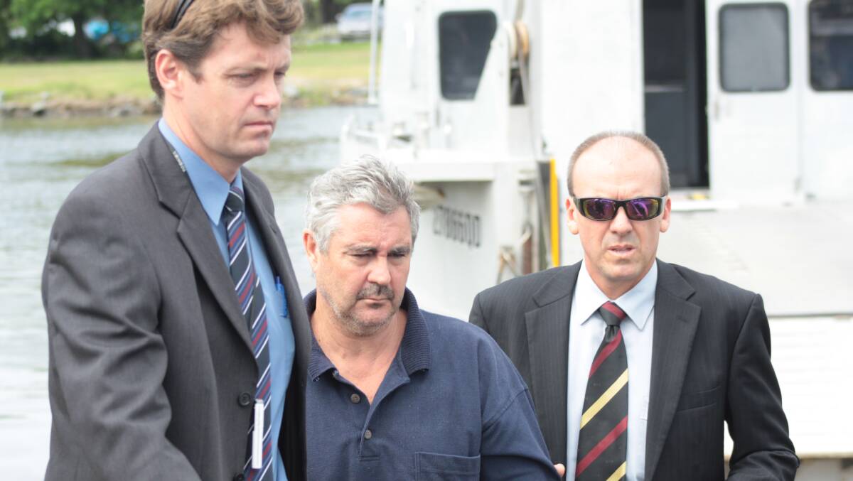 Detective Sergeant Justin Suffolk, left, on the police barge after arresting Steven Mark John Fennell for the murder of Macleay Island grandmother Liselotte Watson in March 2013.  