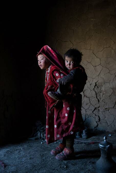 A young girl gives her brother a piggyback ride. Pic: Marta Pascual Juanola. 