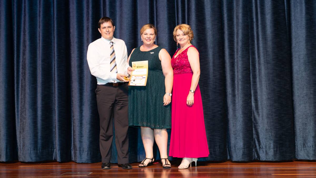 TAKE TWO: MN Jewellery Design owners Matthew and Rebecca Neale accept their award from Karen Davy of Nu Bolt & Hose Supplies. Photo: Studio 4 Photography.