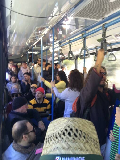 PACKED: A full bus travelling between the ferry terminal and Point Lookout on Sunday. In contrast, some island businesses say Straddie visitor numbers have been a fraction of what they usually are.