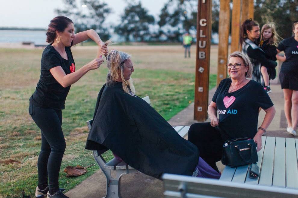 HAIRCUT: Hair Aid founder Selina Tomasich (right) at a community cut event.
