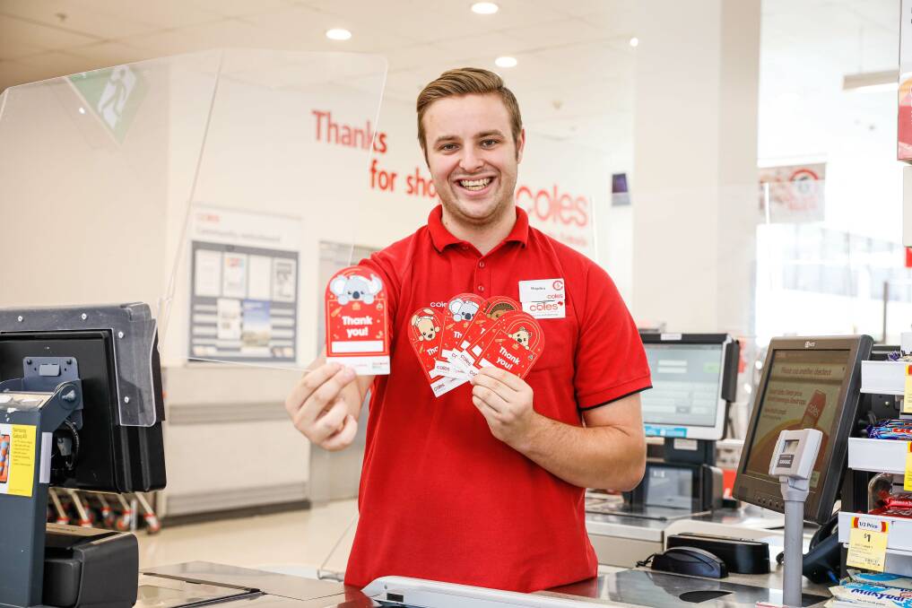 HELPING THE VULNERABLE: Hayden Allen with Coles Christmas donation cards.