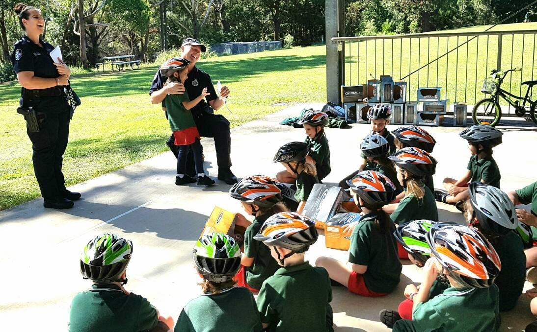 Police gift more than 500 bike helmets to bay island students