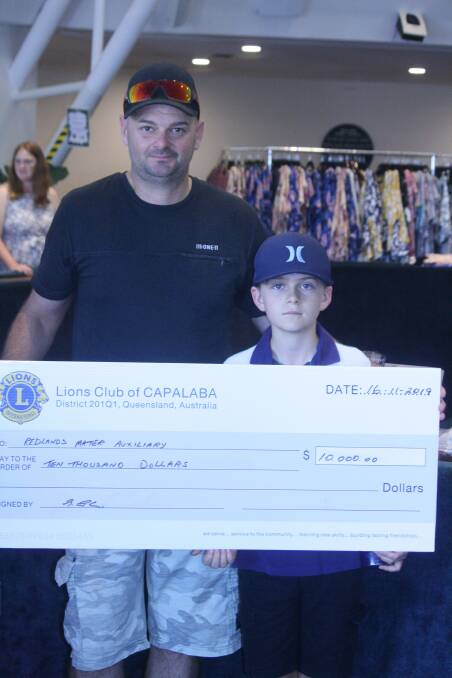 HONOUR: Glenn and Isaac Constable with the cheque presented to the Mater Redlands Auxiliary.