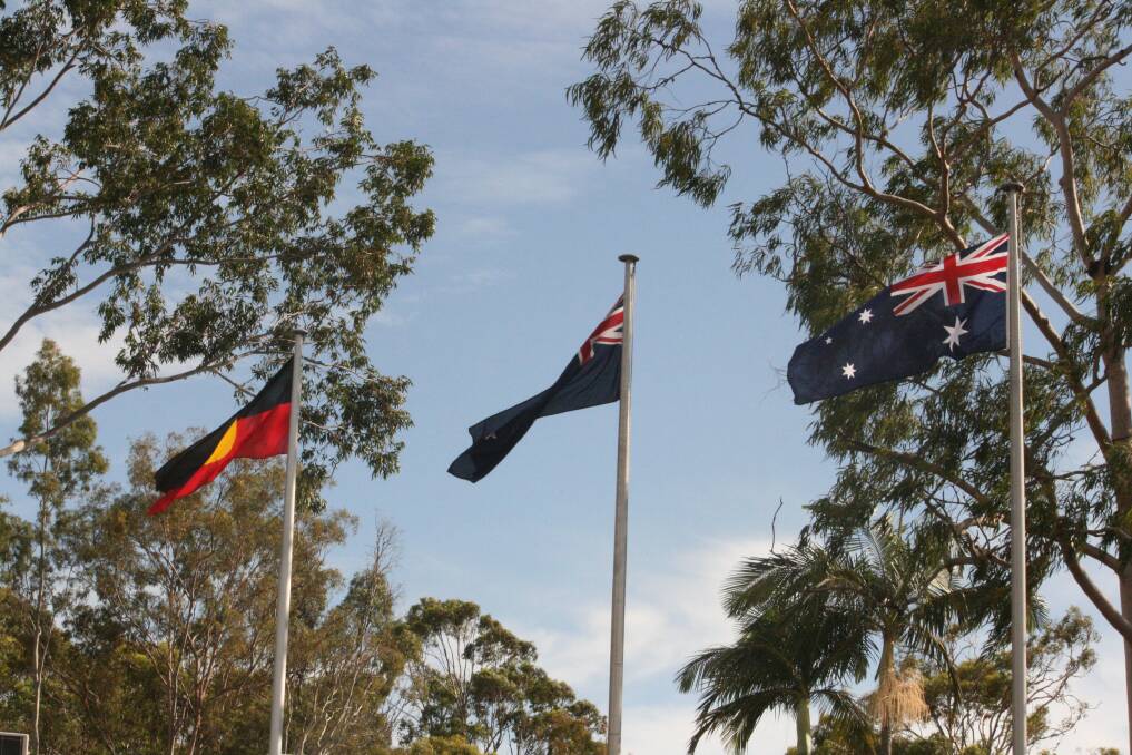 FLYING HIGH: The Aboriginal, New Zealand and Australian flags flying at Vienna Woods State School's Anzac Day ceremony on Wednesday.