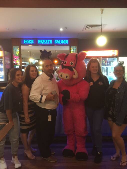 WINNERS: Robert Bucci and his family with Hog's Breath staff and mascot Hogster.