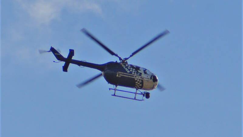 CHOPPER: A police helicopter over Wellington Point today. Photo: Malakai Keen