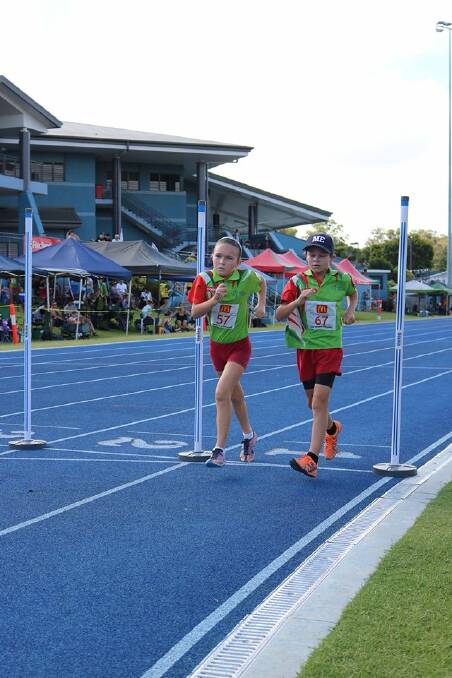 HEAD TO HEAD: Redlands Little Athletics club members Makenna Clarke and Flynn Callaghan battled it out at the finish line in a race walking event during the club carnival. Photo: Amber Callaghan.