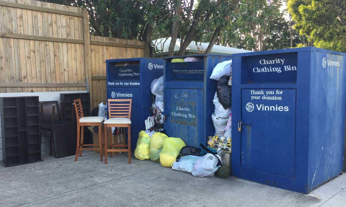 DONATION OVERFLOW: Furniture had been dumped and bags had been stuffed between Vinnies donation bins at St Rita's Catholic Primary School earlier this week.